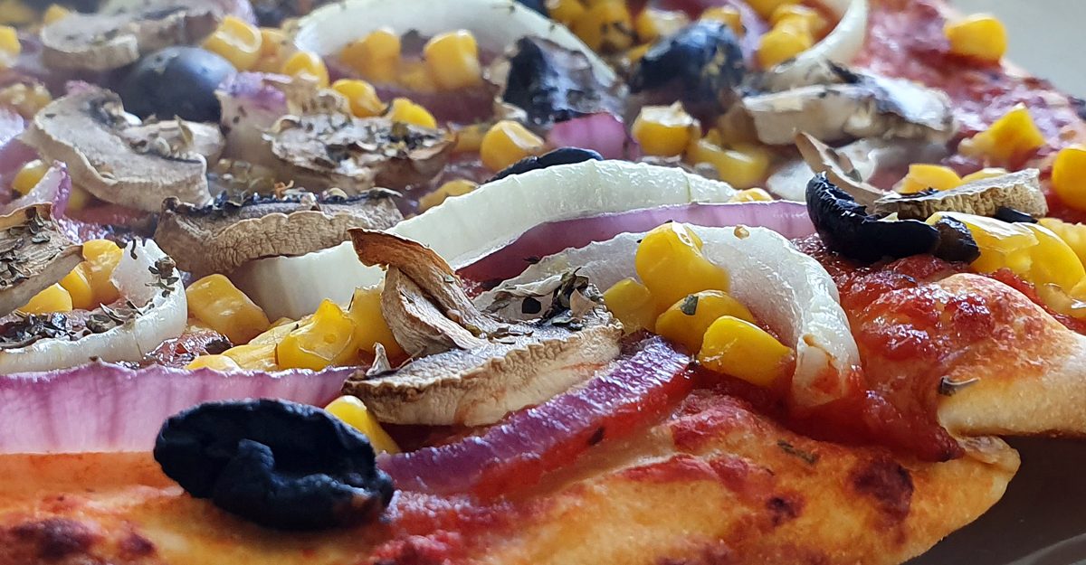 Pizza with onions, mushroom, olives and sweetcorn